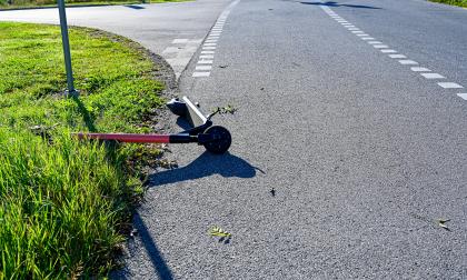 electric scooter lying on tarmac and grass in Orebro Sweden