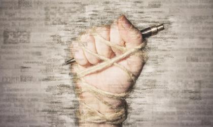 Hand with pen tied with rope, depicting the idea of freedom of the press or freedom of expression. Mixed media.