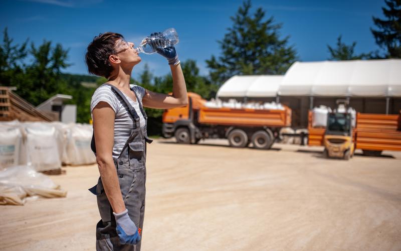 Thirsty Female Blue-collar Worker in Ore Processing Plant.